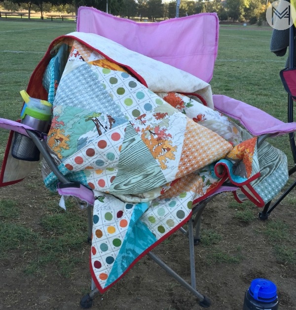 child using quilt at football